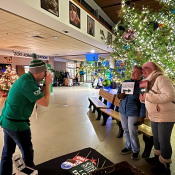 Area Manager Ray Guardiola takes polaroid photos of guests