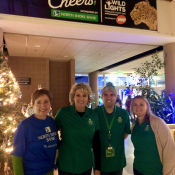 Business Banking Lending Sales Specialist Jody Moore,  Talent Acquisition Manager Janet Rosenthal, Area Manager Ray Guardiola and Credit Analyst Emily Curro pose under the North Shore Bank sponsorship banner